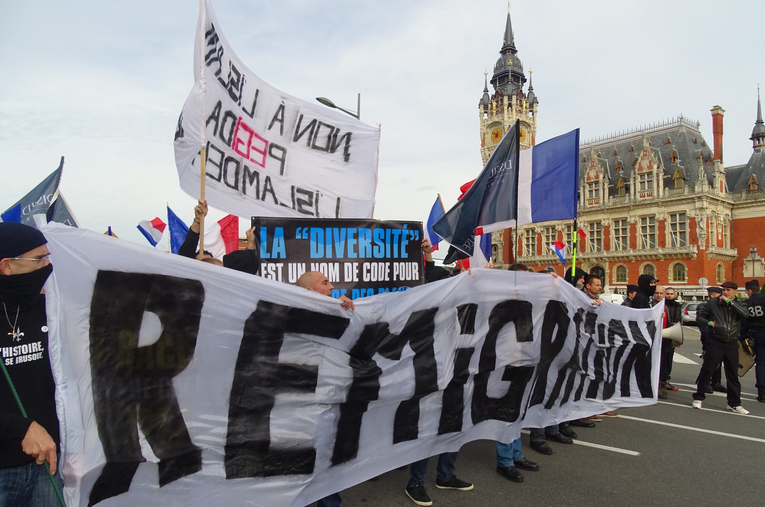 Manifestation avec banderole « Remigration » dès 2015 dans une manifestation oppose à l'installation de migrants à Calais.
